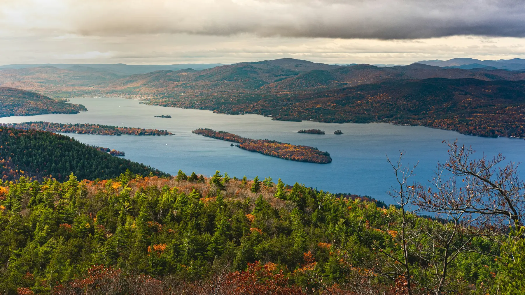 Aerial view of Lake George winding through the Adirondack Mountains in autumn
